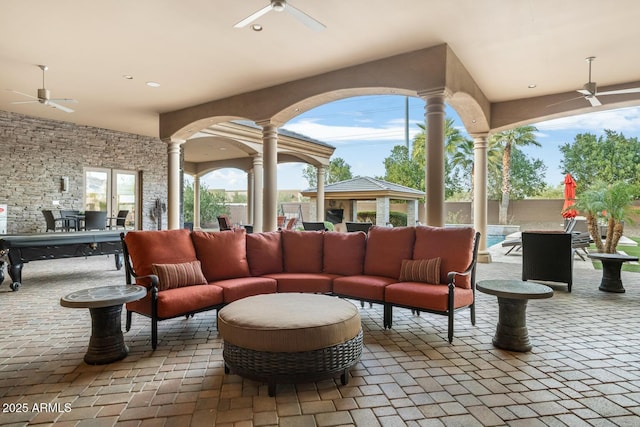 view of patio / terrace with ceiling fan, a gazebo, and outdoor lounge area