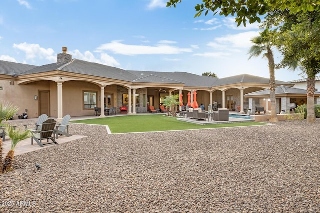 back of house featuring outdoor lounge area and a patio