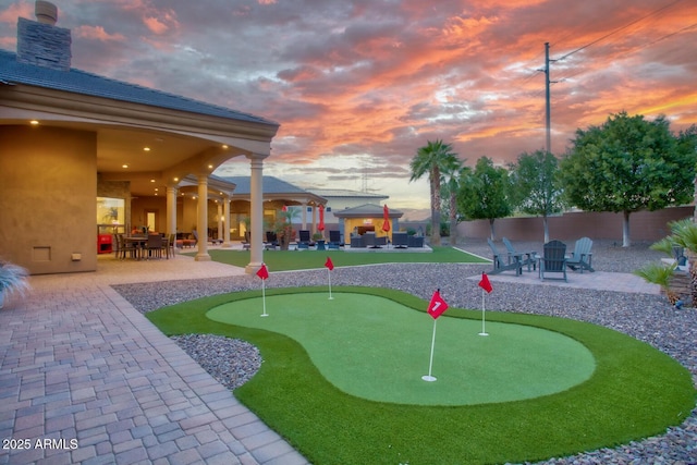 view of property's community with an outdoor fire pit and a patio