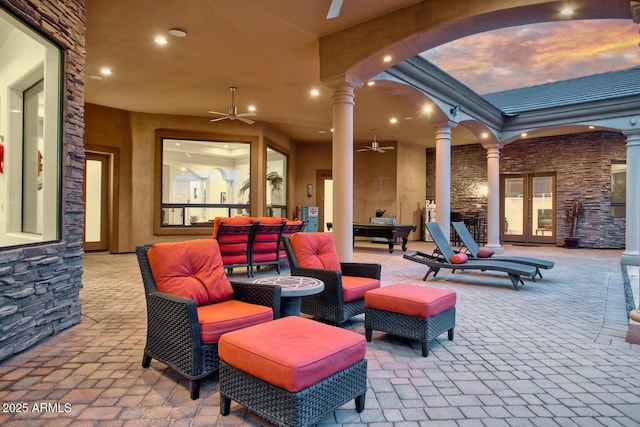 view of patio / terrace featuring ceiling fan, french doors, and an outdoor living space