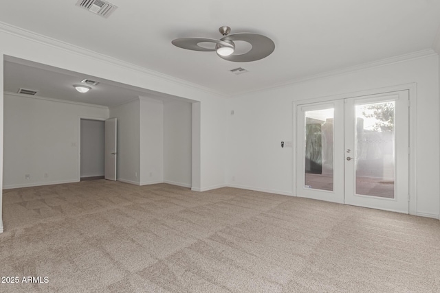 unfurnished room with crown molding, ceiling fan, light carpet, and french doors