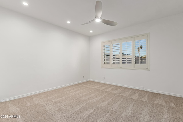 unfurnished room with ceiling fan and carpet