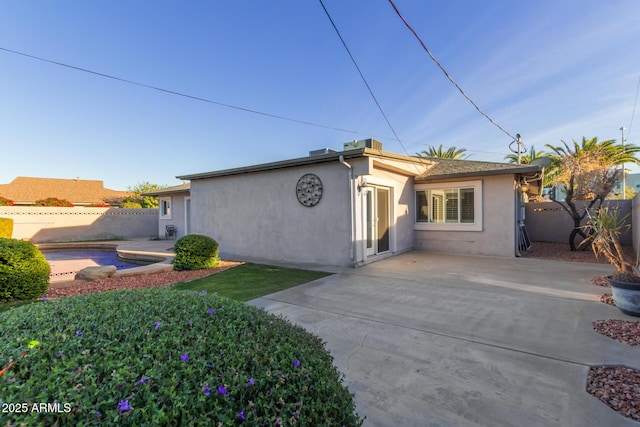 rear view of property featuring a patio area