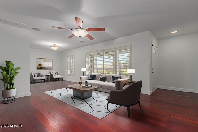 living room featuring ceiling fan and dark hardwood / wood-style floors