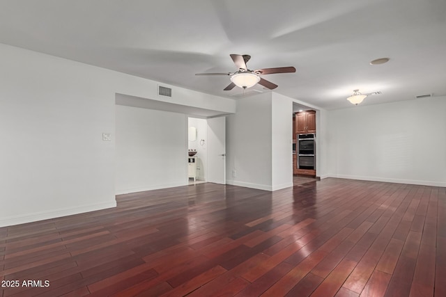 empty room featuring dark wood-type flooring and ceiling fan