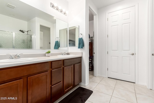 3415 S 75th Dr, Phoenix, AZ 85043 - bathroom featuring a shower stall, double vanity, tile patterned flooring, and a spacious closet