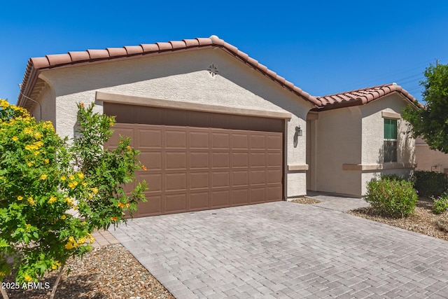3415 S 75th Dr, Phoenix, AZ 85043 - mediterranean / spanish house featuring a tile roof, an attached garage, stucco siding, and decorative driveway