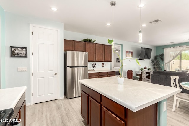 3415 S 75th Dr, Phoenix, AZ 85043 - kitchen featuring appliances with stainless steel finishes, light wood-style flooring, light countertops, decorative light fixtures, and recessed lighting