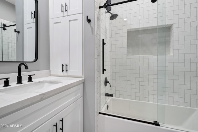 bathroom featuring vanity and shower / bath combination with glass door