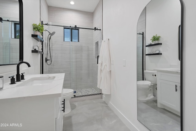 bathroom featuring vanity, toilet, and a shower with door