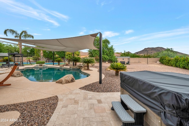 view of pool featuring a mountain view and a patio