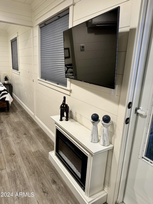 interior space featuring hardwood / wood-style flooring and wood walls