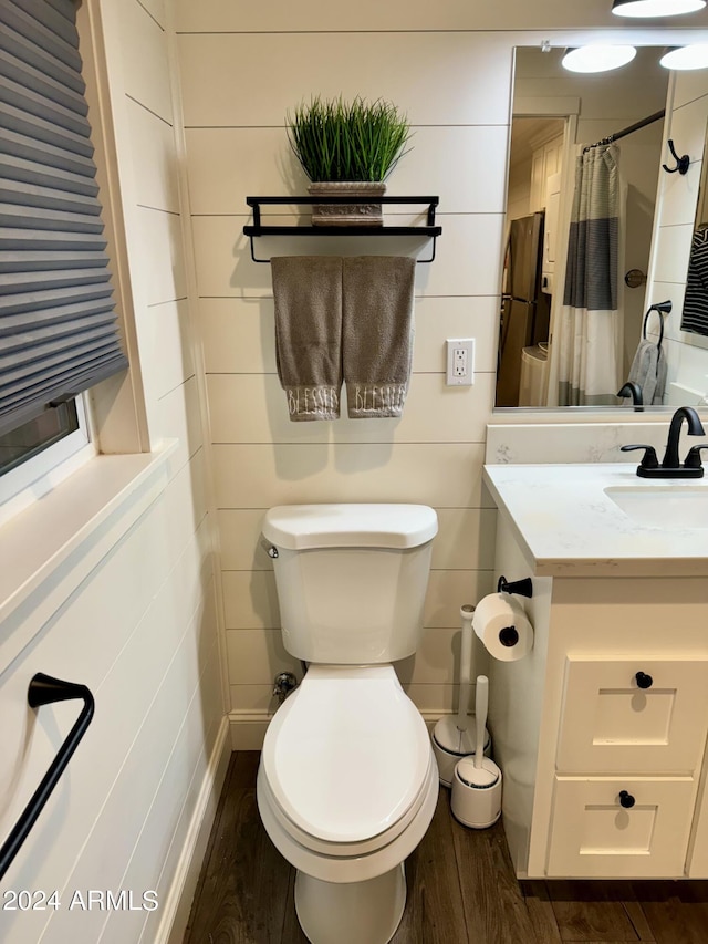 bathroom featuring hardwood / wood-style flooring, vanity, toilet, and a shower with curtain