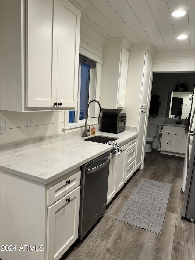 kitchen featuring light stone counters, sink, white cabinetry, and stainless steel appliances