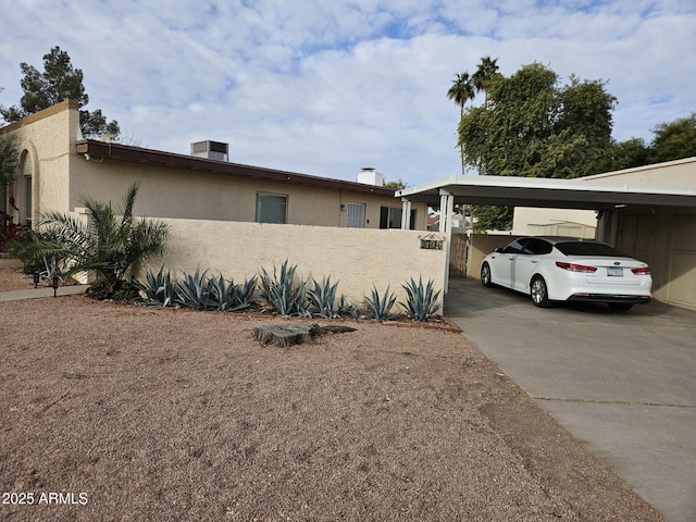 view of side of property featuring a carport