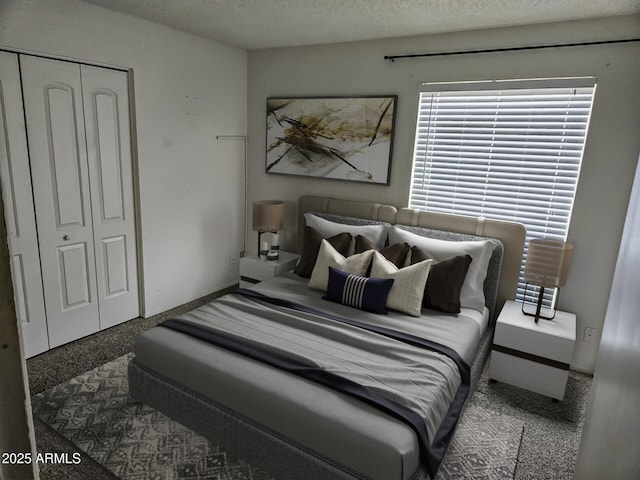 carpeted bedroom with a closet and a textured ceiling