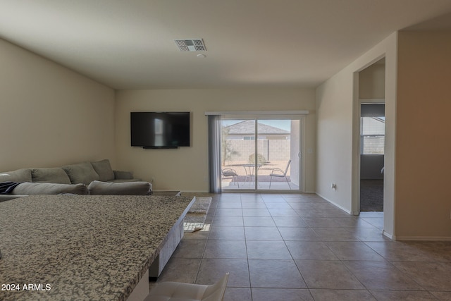 unfurnished living room with light tile patterned flooring