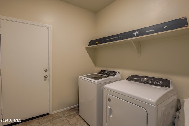 laundry area featuring light tile patterned floors and washing machine and clothes dryer