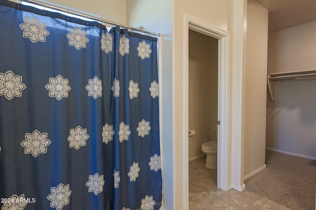 bathroom with tile patterned flooring and toilet