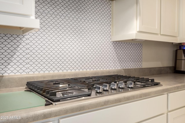 details with light countertops, white cabinetry, and stainless steel gas stovetop