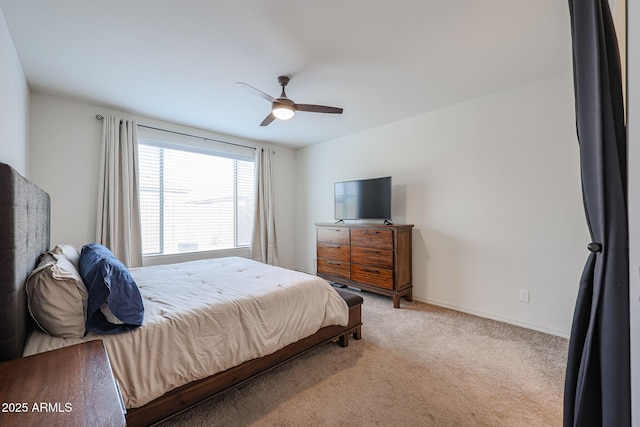 bedroom featuring baseboards, a ceiling fan, and light colored carpet