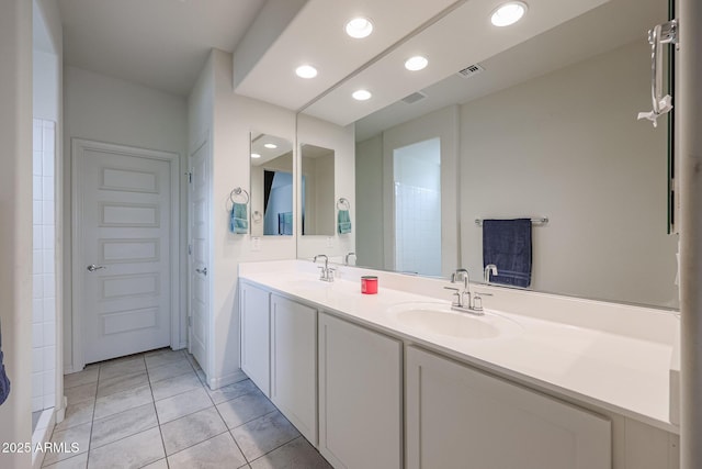 bathroom featuring tile patterned flooring, recessed lighting, a sink, visible vents, and double vanity