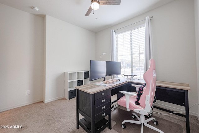 carpeted home office featuring a ceiling fan and baseboards