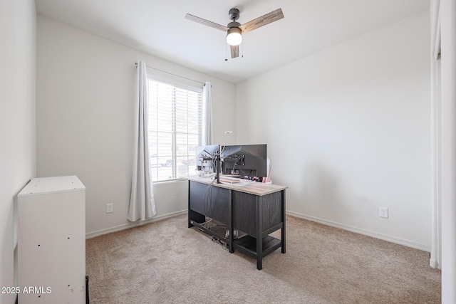 office area with ceiling fan, baseboards, and light colored carpet