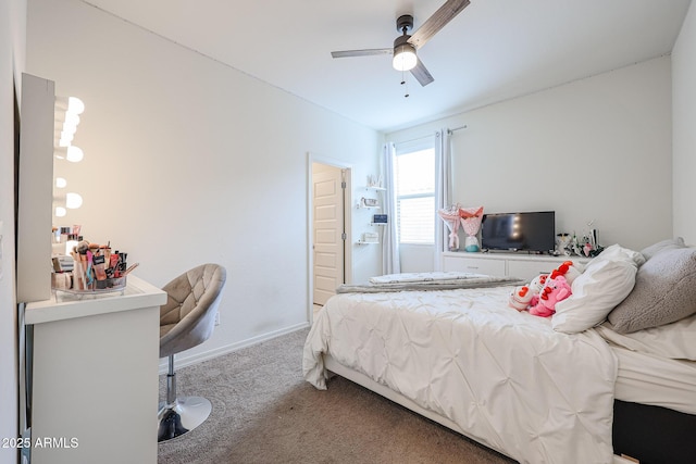 carpeted bedroom with ceiling fan and baseboards