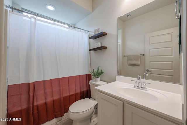 bathroom featuring shower / bath combo with shower curtain, vanity, toilet, and tile patterned floors