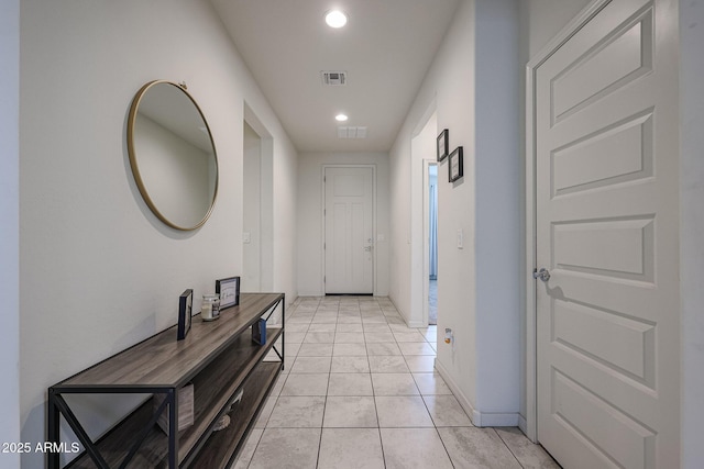 hallway featuring baseboards, visible vents, and recessed lighting