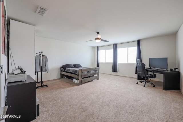 bedroom featuring baseboards, a ceiling fan, visible vents, and light colored carpet