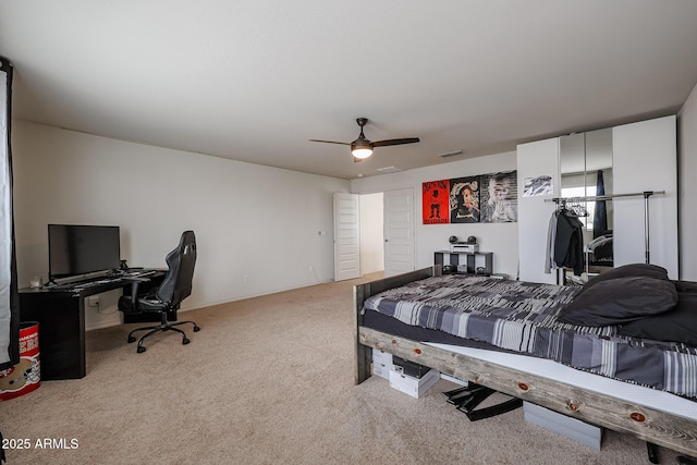 bedroom with visible vents, a ceiling fan, and light colored carpet