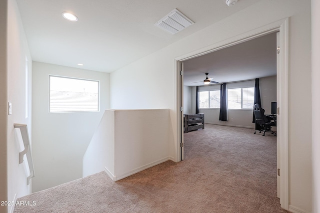 hall featuring visible vents, baseboards, light colored carpet, an upstairs landing, and recessed lighting