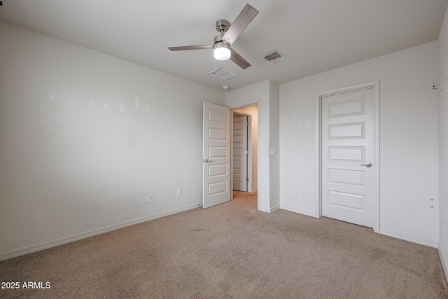 unfurnished bedroom featuring light colored carpet, visible vents, and baseboards