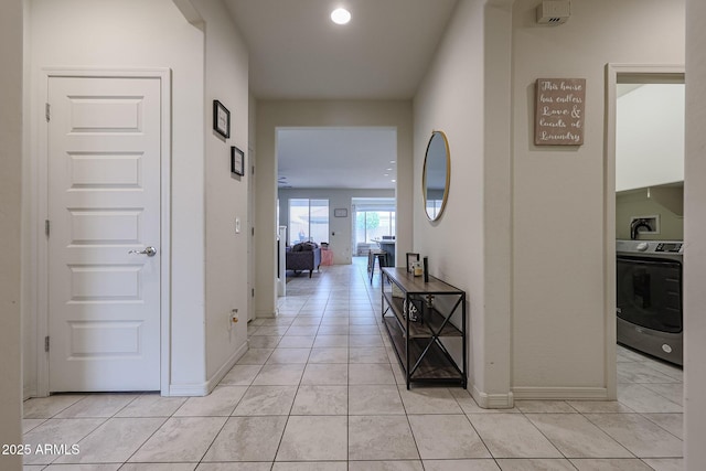 hallway featuring light tile patterned floors and baseboards