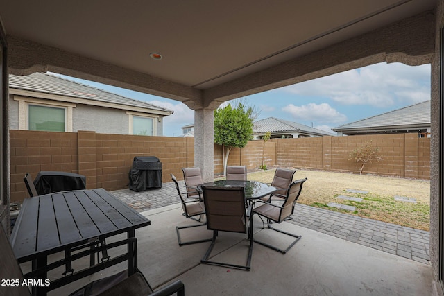 view of patio with outdoor dining space and a fenced backyard