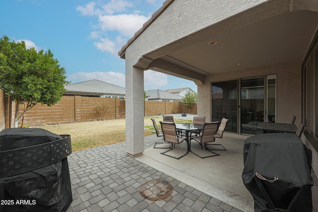 view of patio / terrace featuring outdoor dining area, grilling area, and a fenced backyard