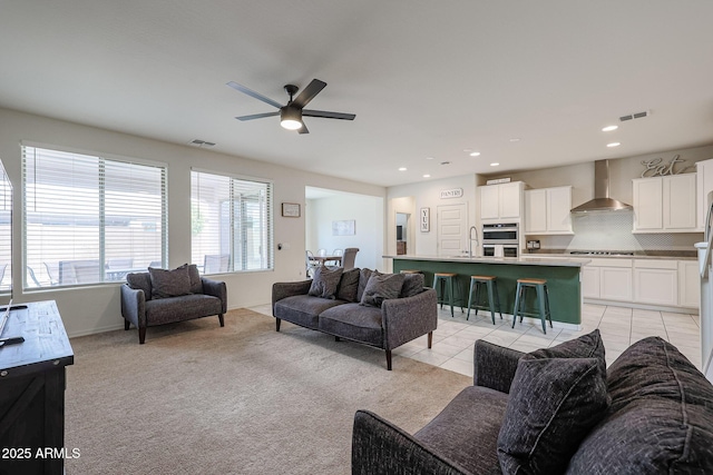 living room with light tile patterned floors, light carpet, visible vents, and recessed lighting