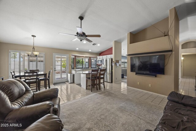 843 E Vera Ln, Tempe, AZ 85284 - living area with light tile patterned floors, vaulted ceiling, ceiling fan, plenty of natural light, and a chandelier