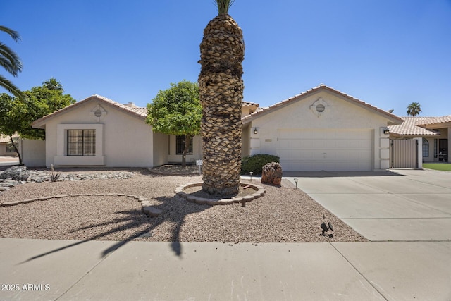 843 E Vera Ln, Tempe, AZ 85284 - mediterranean / spanish home featuring stucco siding, an attached garage, driveway, and a tiled roof