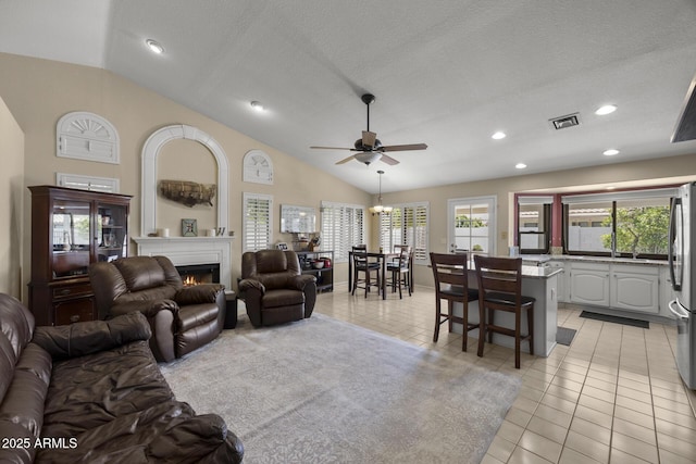 843 E Vera Ln, Tempe, AZ 85284 - living room with lofted ceiling, a warm lit fireplace, ceiling fan, light tile patterned flooring, and recessed lighting