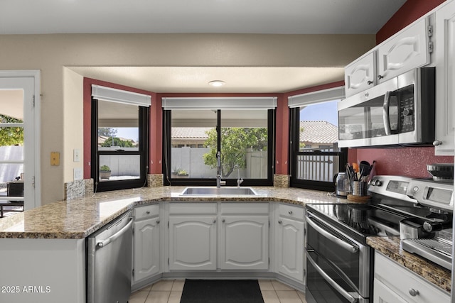 843 E Vera Ln, Tempe, AZ 85284 - kitchen featuring stainless steel appliances, a sink, white cabinetry, and light tile patterned floors