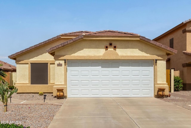 view of front facade featuring a garage, driveway, and stucco siding