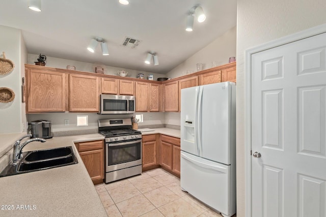 kitchen featuring light countertops, a sink, appliances with stainless steel finishes, light tile patterned floors, and visible vents