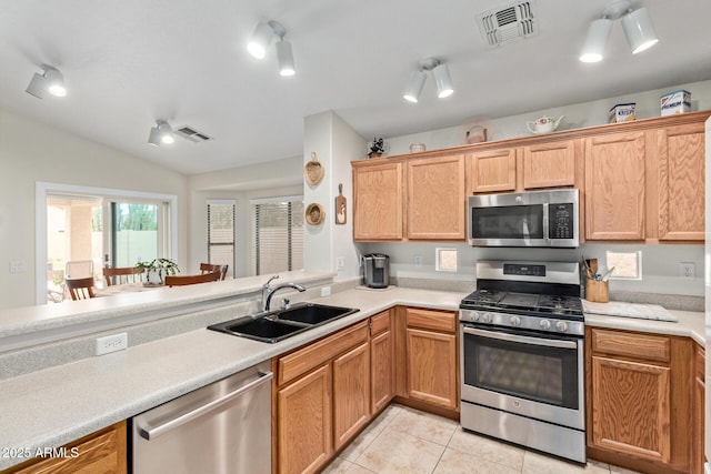 kitchen with a sink, visible vents, appliances with stainless steel finishes, and light tile patterned floors