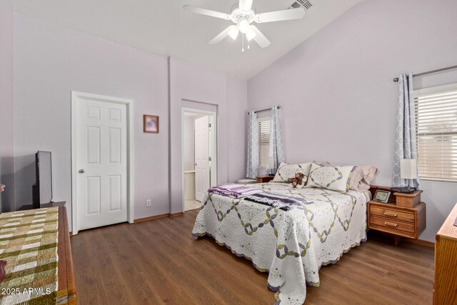 bedroom with baseboards, lofted ceiling, wood finished floors, and a ceiling fan