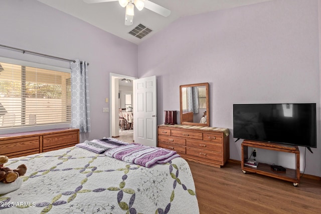bedroom featuring visible vents, high vaulted ceiling, wood finished floors, and a ceiling fan