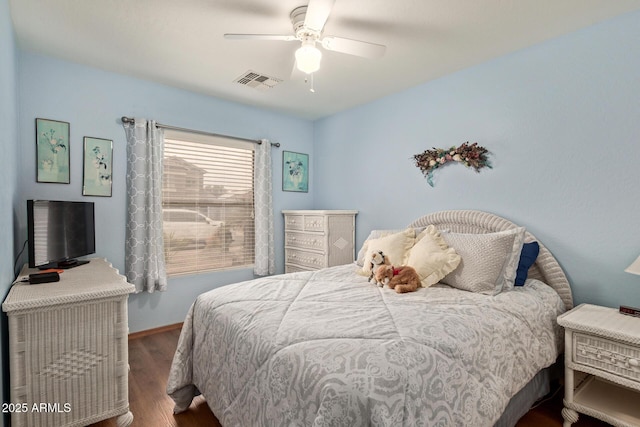 bedroom with wood finished floors, baseboards, ceiling fan, and visible vents
