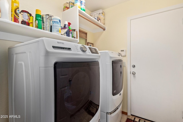 washroom featuring washer and clothes dryer and laundry area